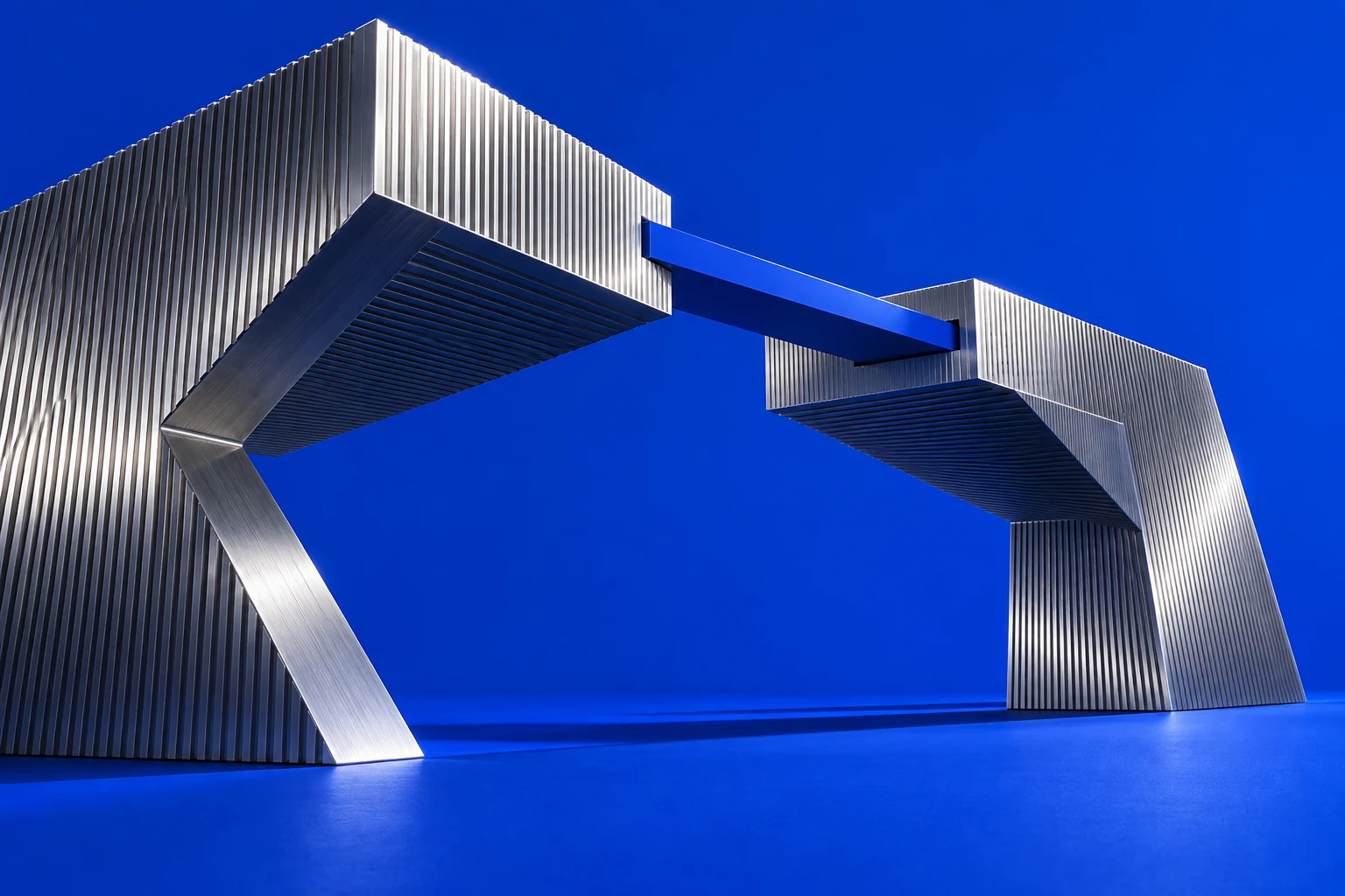 Two machined structures joined by a blue bridge